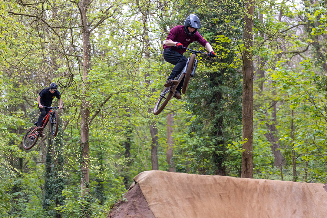 Two airborne BMX stunt riders